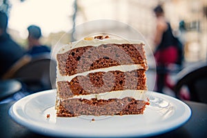 Cake slice on white plate in paris, france, dessert. Cake with cream, food. Temptation, appetite concept. Dessert, food