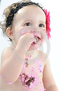 Cake smash shoot: Messy baby girl eating birthday cake!