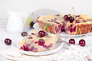 Cake with sweet cherries on a plate