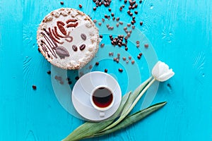 Cake, tulips and coffee on blue background