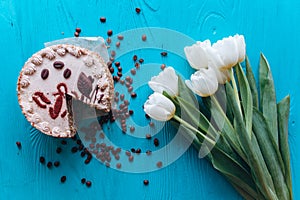 Cake, tulips and coffee on blue background