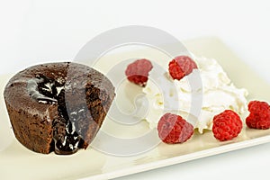 Cake volkano of chocolate with cream and raspberry.