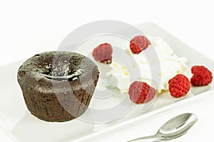 Cake volkano of chocolate with cream and raspberry.