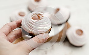 Cake, white-pink marshmallows, jam, cookies, chocolate on a blackboard, light background. Close-up