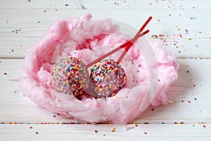 Cakepops in the nest made from candy-floss, white background
