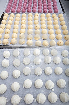 Cakes on automatic conveyor belt or line, baking process in confectionery factory. Food industry, cookie production