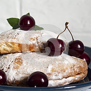 Cakes with cherries and a leaf of mint.