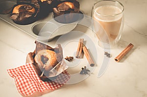 Cakes with a chocolate stuffing and sticks of cinnamon/cakes with a chocolate stuffing and sticks of cinnamon on a white table