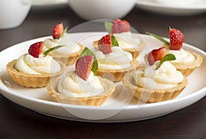 Cakes, cupcakes with fresh fruits (strawberries), whipped cream and mints