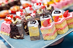 Cakes with different decorations on the plate