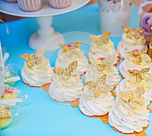 Cakes meringue on a plate on a festive table. Candy Bar.