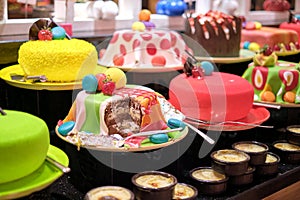 Cakes and pastries fill the frame with tempting hues. They represent a celebration of taste amidst debates on food