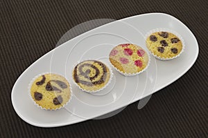 Cakes on a plate over brown towel