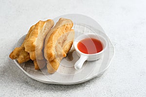 Cakwe or Cakue or Youtiao is traditional Chinese snack, long golden-brown deep-fried strip of dough.