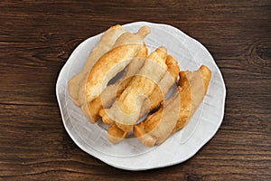 Cakwe or Cakue or Youtiao is traditional Chinese snack, long golden-brown deep-fried strip of dough.