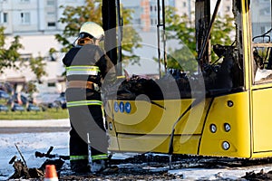 Cal fire firefighter using axe while extinguish bus fire