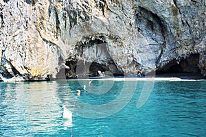 Remarkable shingle beaches below natural grottos. Palinuro, Italy. photo