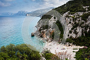 Cala Gonone beach in Sardinia with unrecognizable people on an o