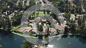 Calabasas luxury houses beside lake in wealthy neighborhood, aerial view