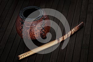 Calabash and bombilla on wooden background photo