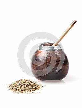 Calabash and bombilla with yerba mate isolated on white photo