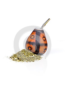 Calabash for yerba mate with its bombila with a lot of yerba mate on a white background