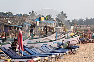 Beach beds without people outside a shack at the popular tourist beach in Goa