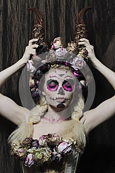 Calavera Catrina in the dark. Girl with sugar skull makeup. Dia de los muertos. Day of The Dead. Halloween