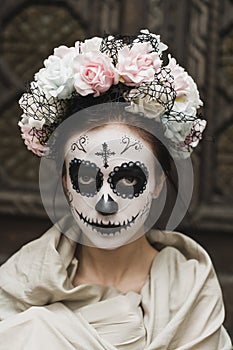 Calavera Catrina in the dark. Girl with sugar skull makeup. Dia de los muertos. Day of The Dead. Halloween