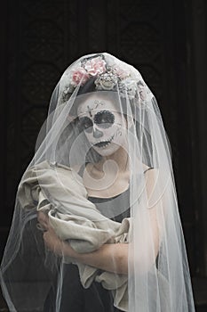 Calavera Catrina in the dark. Girl with sugar skull makeup. Dia de los muertos. Day of The Dead. Halloween