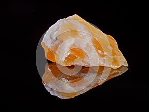 Calcite orange close-up. Black background. Macro image. photo