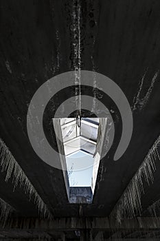 calcium carbonate formations on the ceiling of an huge abandoned concrete warehouse