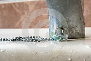 Calcium deposits wet chain bathroom sink stopper