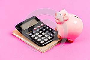 Calculate profit. Piggy bank pink pig and calculator. Economics and finance. Credit concept. Money saving. Save money