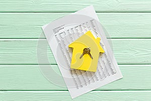 Calculate taxes for house with figure, keys, table on mint green wooden background top view