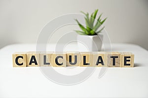 The calculate word. Wooden cubes with text calculate.