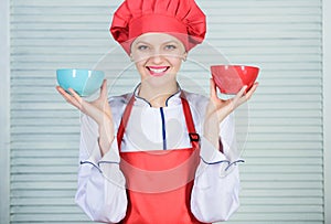 Calculate your food servings size. Diet and dieting concept. Woman cook hold bowls. How many portions would you like to