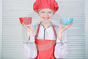 Calculate your food servings size. Diet and dieting concept. Woman cook hold bowls. How many portions would you like to