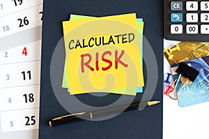 calculated risk - text on yellow paper on blue background, concept photo
