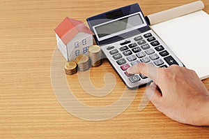 Calculating with Coins stack and paper house and notepad