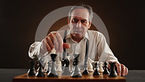 Calculating Senior Chess Player Taking Time to Make Strategic Move