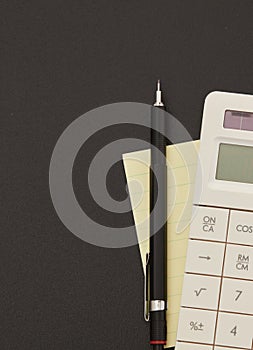 Calculator, adhesive note and pen