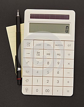 Calculator, adhesive note and pen