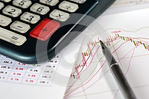 Calculator, ball-point pen, and data analysis chart