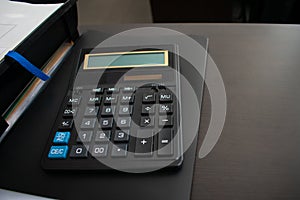 Calculator on black folder on desktop