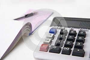 Calculator and books on white