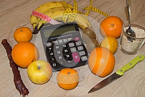 Calculator with cereals, fruit, tape measure and concept of diet and healthy lifestyle