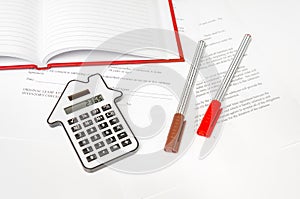 Calculator and contract - mortgage and real estate concept