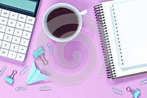 Calculator with cup of coffe isolated on purple background