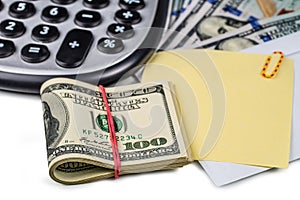 Calculator, dollars, envelope and paper for notes